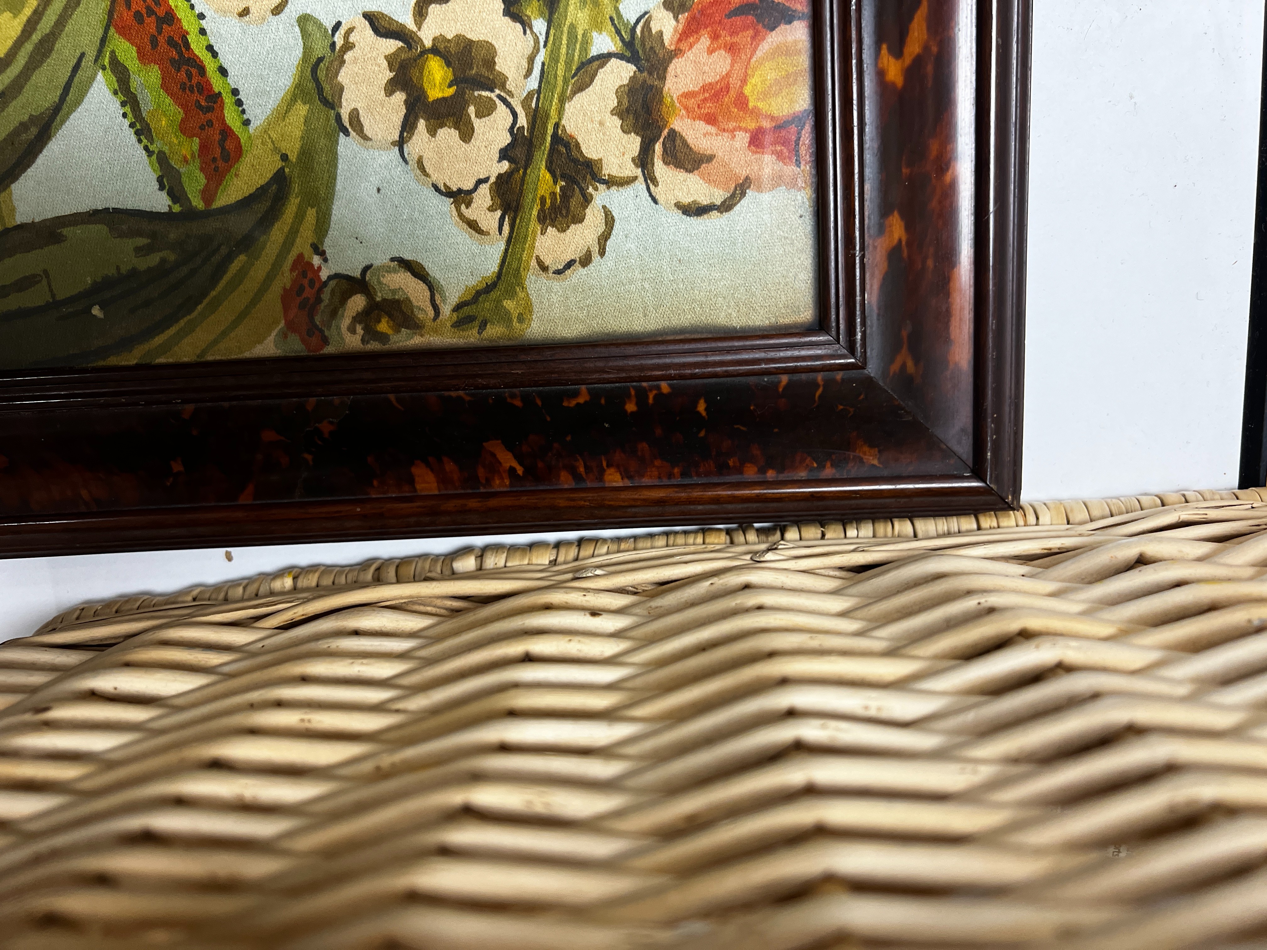 A large rare tortoiseshell picture frame and exotic panel of printed fabric, 70 cms wide x 52 cms high including frame